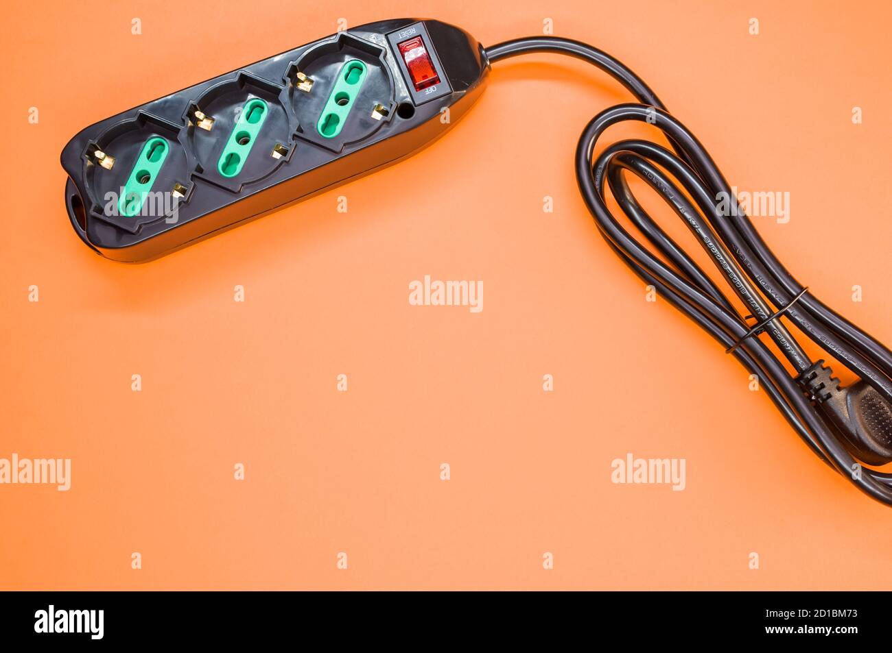 Black surge protector on an orange background Stock Photo Alamy