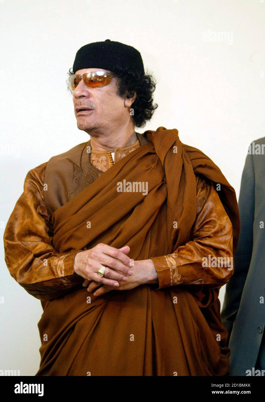 Libyan leader Muammar Gaddafi looks on during his debate on democracy with two Western scholars in the desert in Sebha March 2, 2007, in a move apparently designed to further the resumption of international ties following years of isolation. Speaking on the 30th anniversary of his declaration of a Jamahiriyah or state of the masses, Gaddafi said Libya was embracing globalisation and the outside world after years of sanctions but insisted his experiment in rule by town hall meetings was fairer than the West's ballot box democracy. REUTERS/Louafi Larbi (LIBYA) Stock Photo