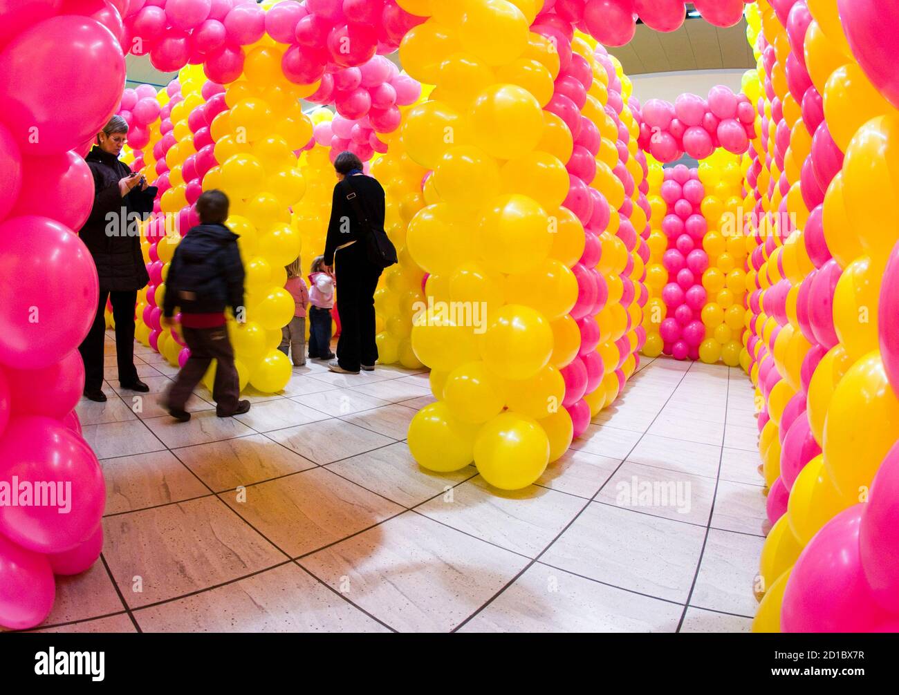 People walk through a temporary labyrinth inside a shopping mall in Allaman  near Lausanne February 4, 2009. Made with 20,000 balloons, it is stated as  world's largest balloon labyrinth. Picture taken February