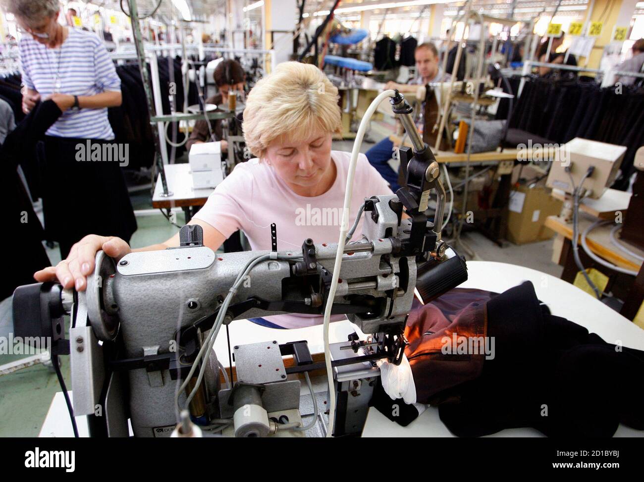 A Bosnian worker sews at the Borac garment maker in the central town of  Travnik June 3, 2009. The factory assembles clothing for labels such as Hugo  Boss, Pierre Cardin and Burberry,