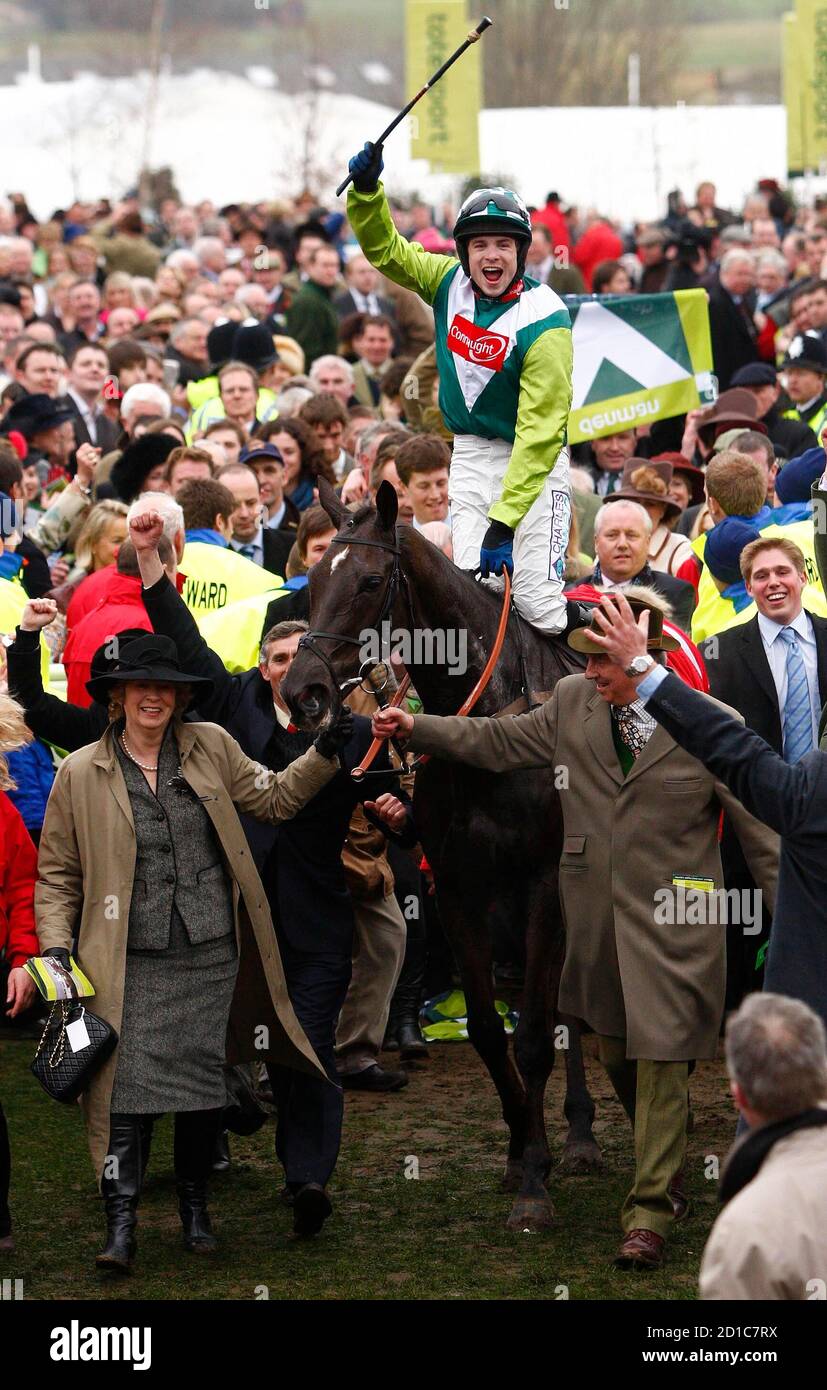 Sam Thomas on Denman celebrates winning the totesport Cheltenham Gold Cup Steeple Chase on the forth day of the Cheltenham Festival horse racing meet in Gloucestershire, western England, March 14, 2008. REUTERS/Eddie Keogh (BRITAIN) Stock Photo