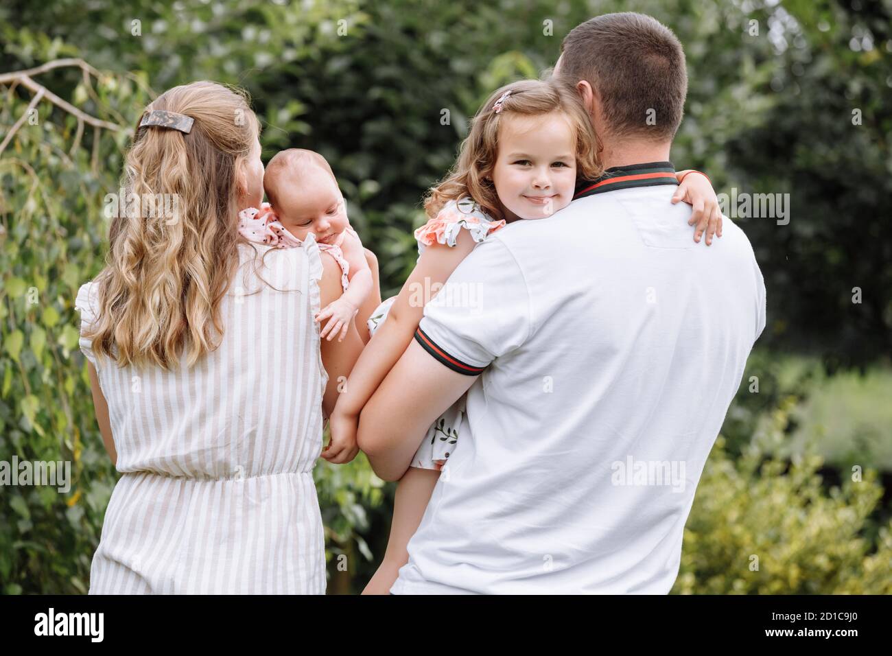 Young couple with newborn daughter in park. happy parenthood, childhood ...