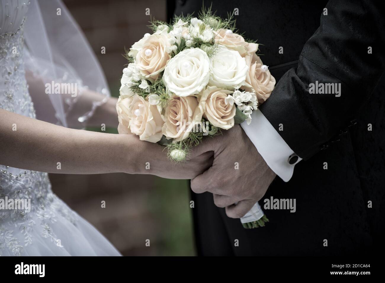 Beautiful wedding roses bouquet in hands of the bride and man Stock ...