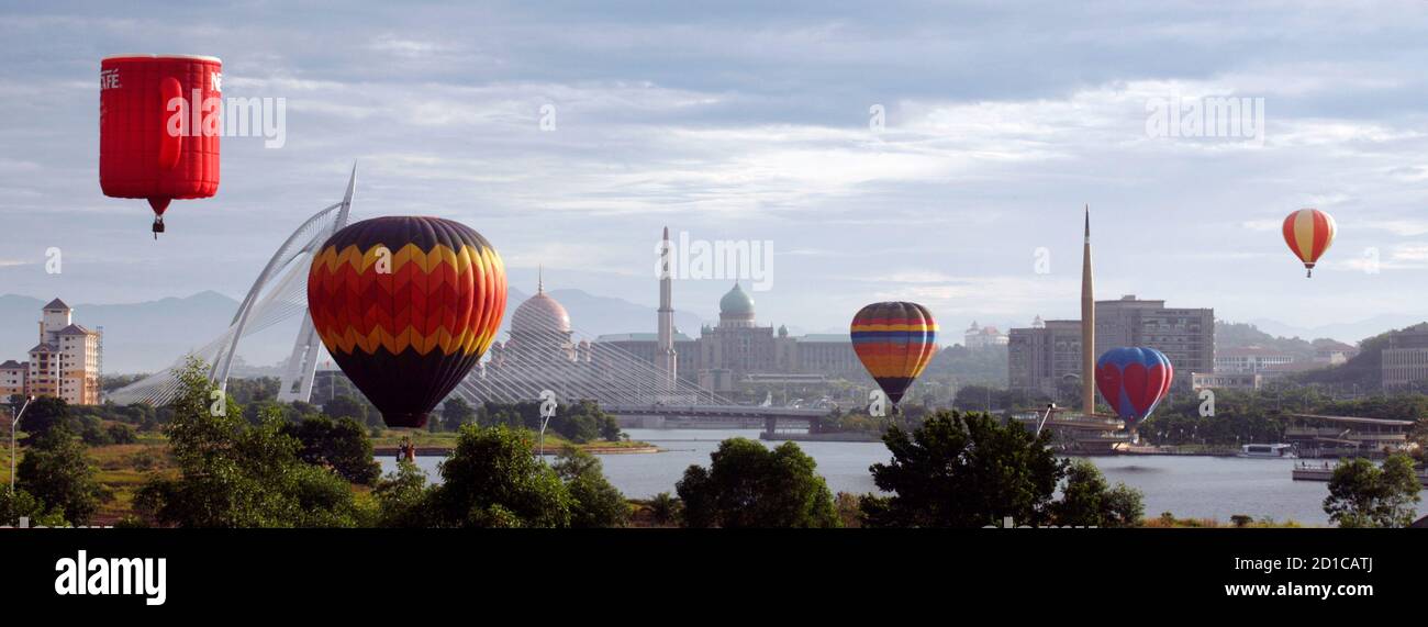Hot air balloons float over Putrajaya during International Hot Air Balloon Fiesta 2009 March 21, 2009. The four-day show ends on Sunday with participants from Belgium, New Zealand, Netherlands, France, United States, Philippines, Switzerland, Japan and Malaysia. REUTERS/Bazuki Muhammad (MALAYSIA SOCIETY) Stock Photo