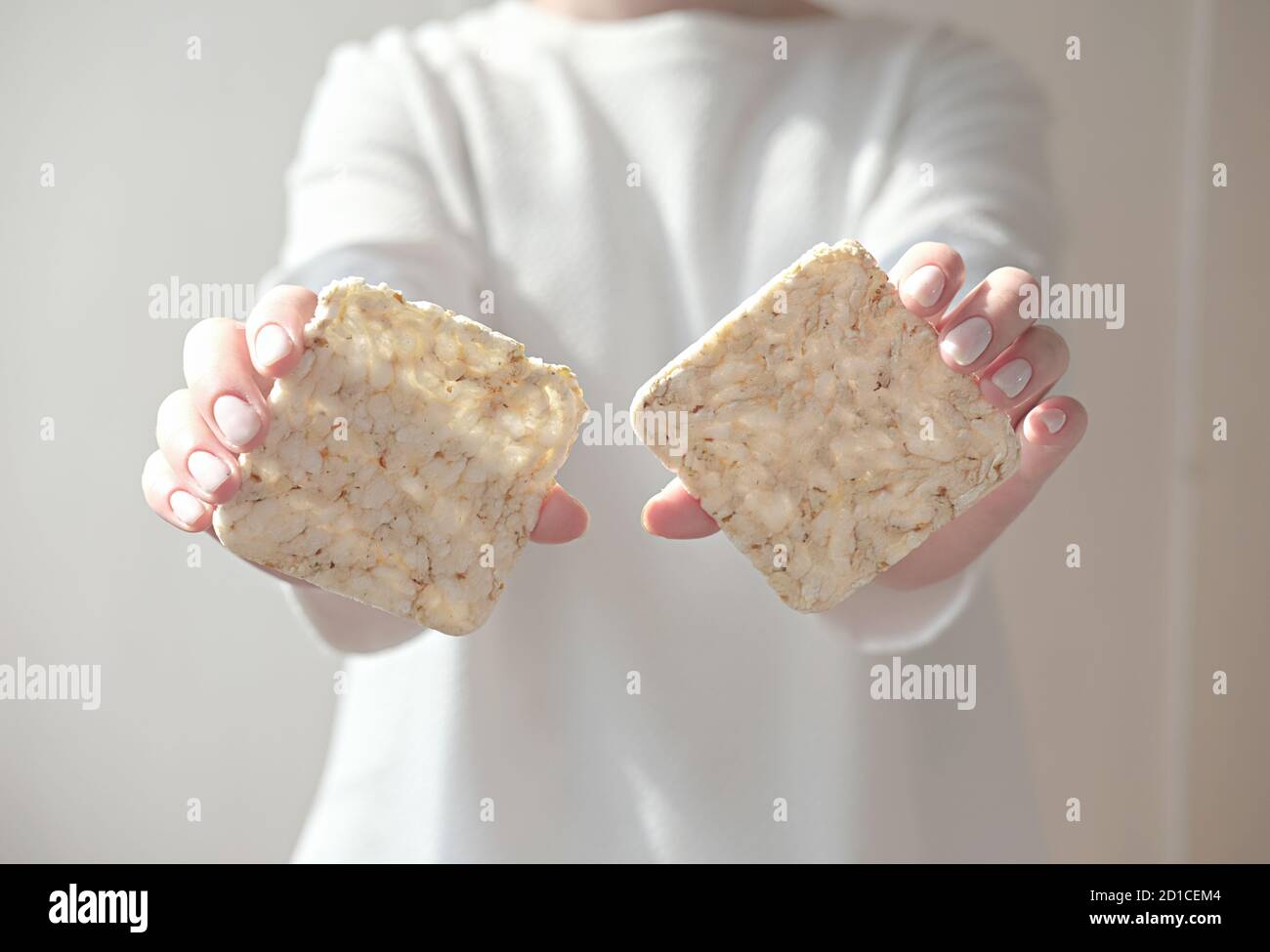 Puff Rice Crispbread girl holding Puffed rice bread , crushed diet crispy square rice ...