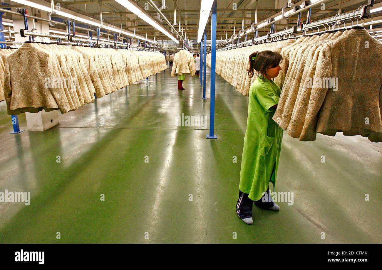 A woman works at the Zara factory at the headquarters of Inditex group in  Arteixo, northern Spain March 29, 2006. Spain's Inditex, owner of the Zara  fashion chain, said it would pay