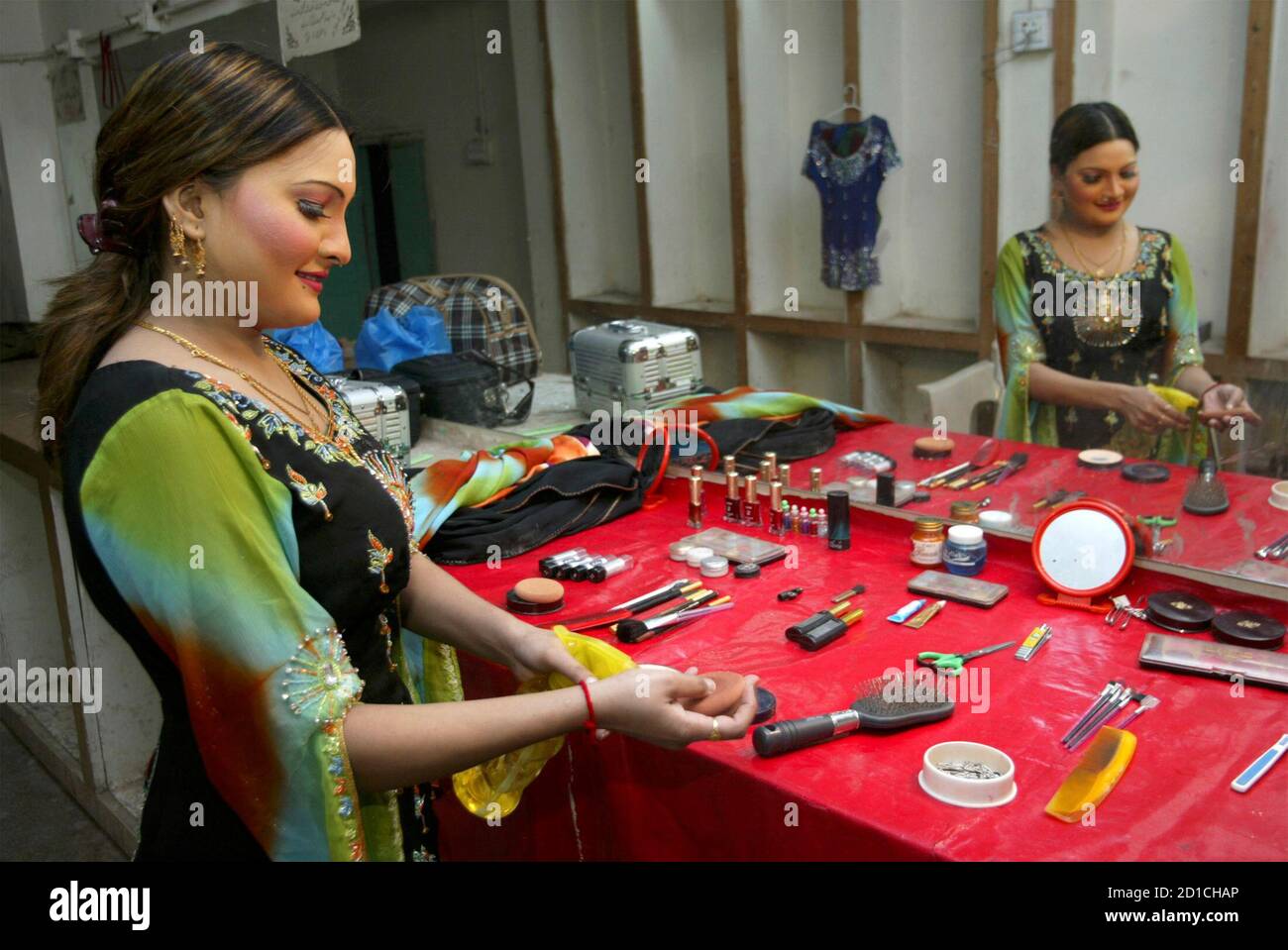 Stage drama artist Shabnam Rani stands inside the make-up room of the  Khayyam theatre in the central city of Multan January 15, 2007. A crowd of  men whistle and cheer as a