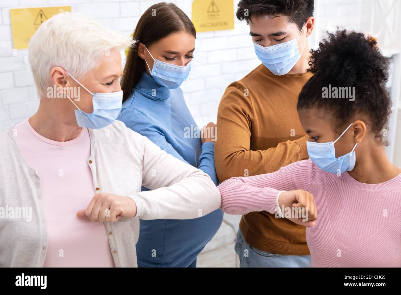 Group Of Diverse People Bumping Elbows Meeting Indoors Stock Photo