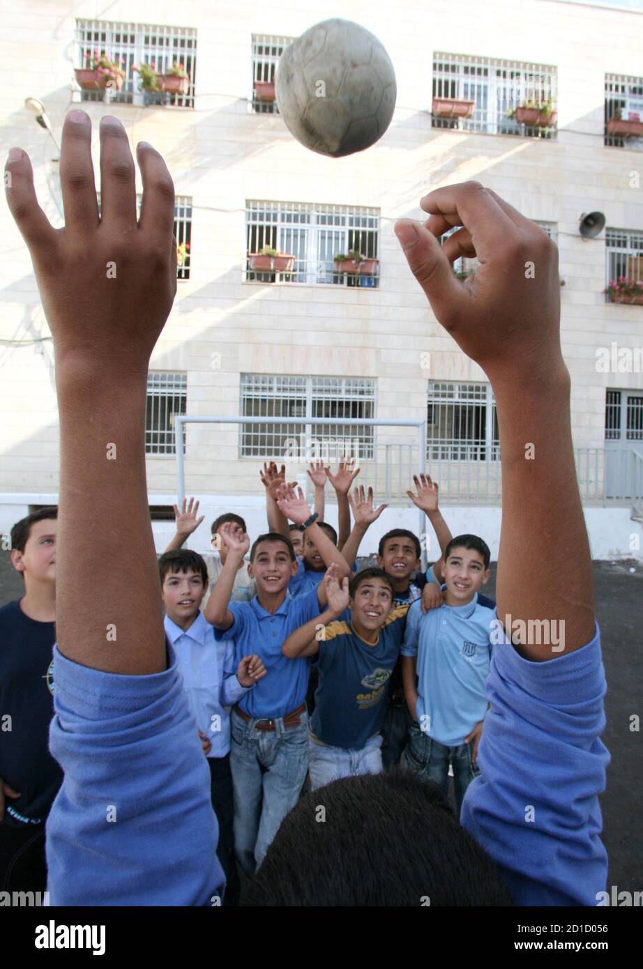 Palestinian youths play together on the third day of the closure of schools affected by a strike in the West Bank city of Hebron September 4, 2006. Tens of thousands of Palestinian government employees began a strike in the West Bank and Gaza on Saturday in protest against unpaid salaries and the perceived failings of the Hamas-led government.  REUTERS/Nayef Hashlamoun (WEST BANK) Stock Photo
