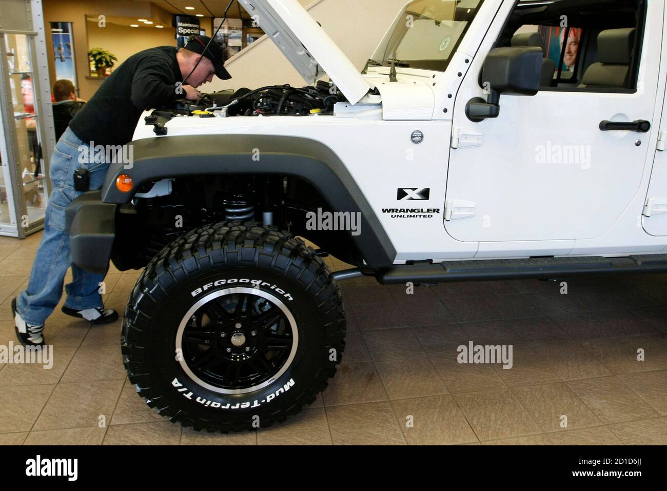 Service customer Shaun Smith looks over a modified 2009 Jeep Wrangler  Unlimted X in the Pro Chrysler Jeep showroom at the Chrysler dealership in  Thornton, Colorado December 22, 2008. The . government