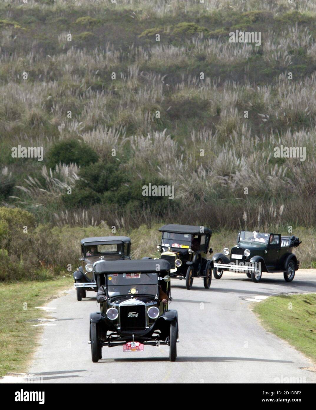 four door ford cars on A 1926 Ford T A 1929 Four Door Ford A 1924 Ford T And A 1929 Ford Phaeton Front To Back Participate In A Classic Car Rally In The Outskirts Of Montevideo