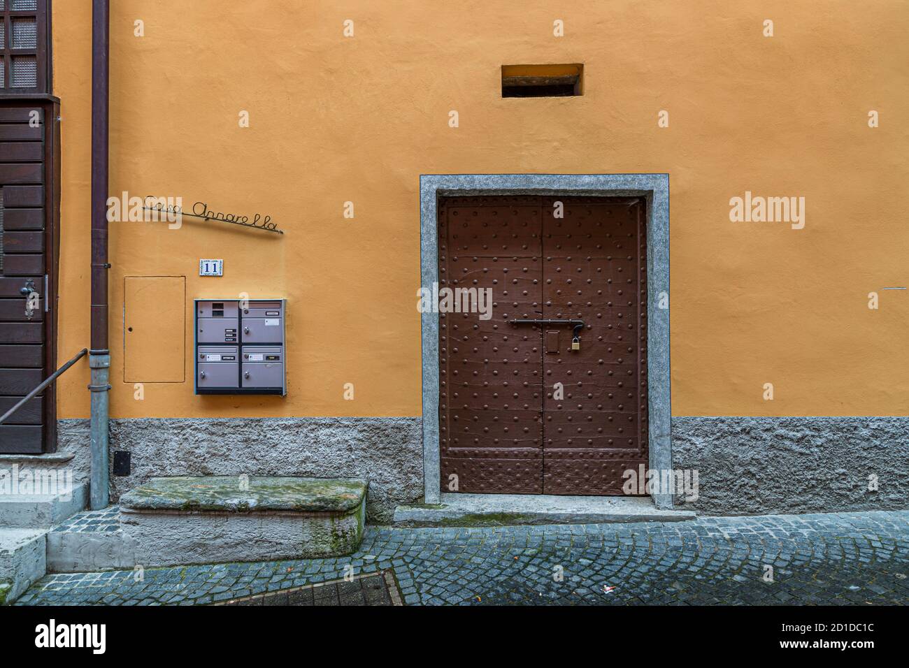 Wooden door of a cantina where food is stored in a cool place. Culinary tour on Lake Lugano in Ticino, Circolo di Carona, Switzerland Stock Photo