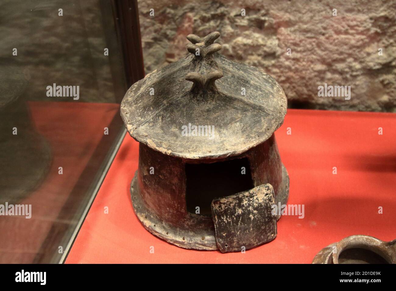 archaeological museum of La Spezia, Italy - summer 2020: cinerary urn in the shape of a hut created in 9th century BC Stock Photo