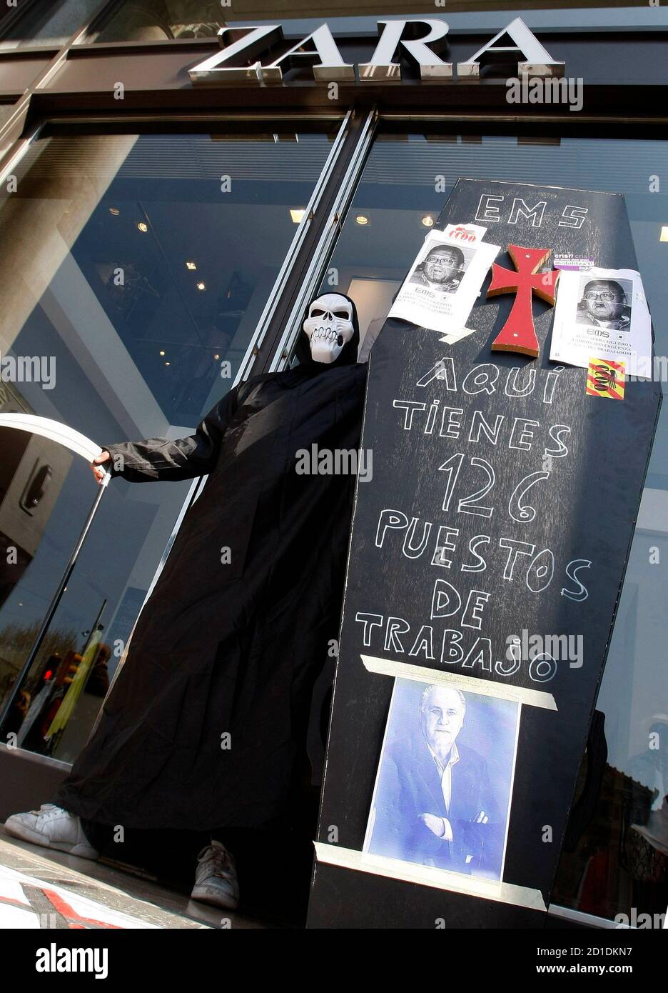An Inditex worker dressed as death stands outside a Zara shop during a  protest against Inditex group job cuts at Passeig de Gracia in central  Barcelona March 19, 2009. The sign reads: 