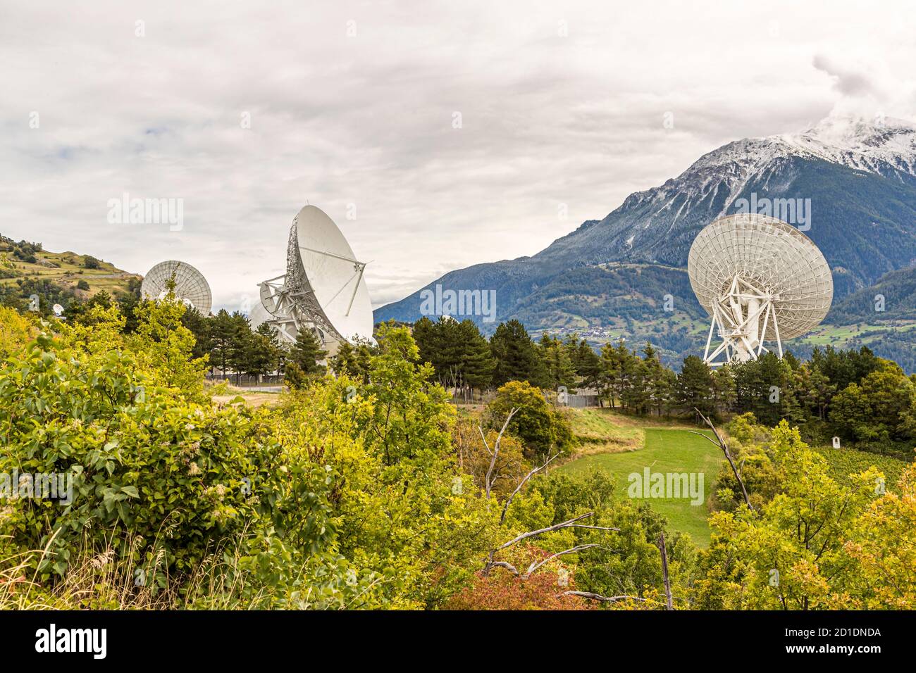 Signal horn ground station with parabolic antennas and satellite dishes in Bretjong near Leuk, Switzerland Stock Photo