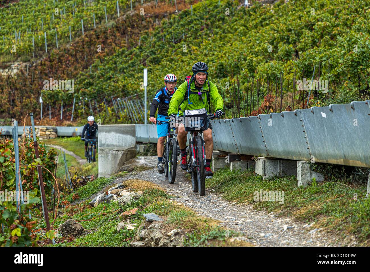 Mountain bikers come to meet you during the suonen hikes in the Swiss Valais, Savièse, Switzerland Stock Photo
