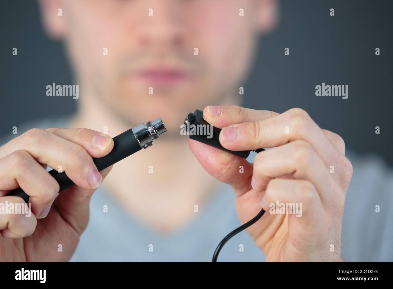 administrator holding network cables connected to servers Stock Photo