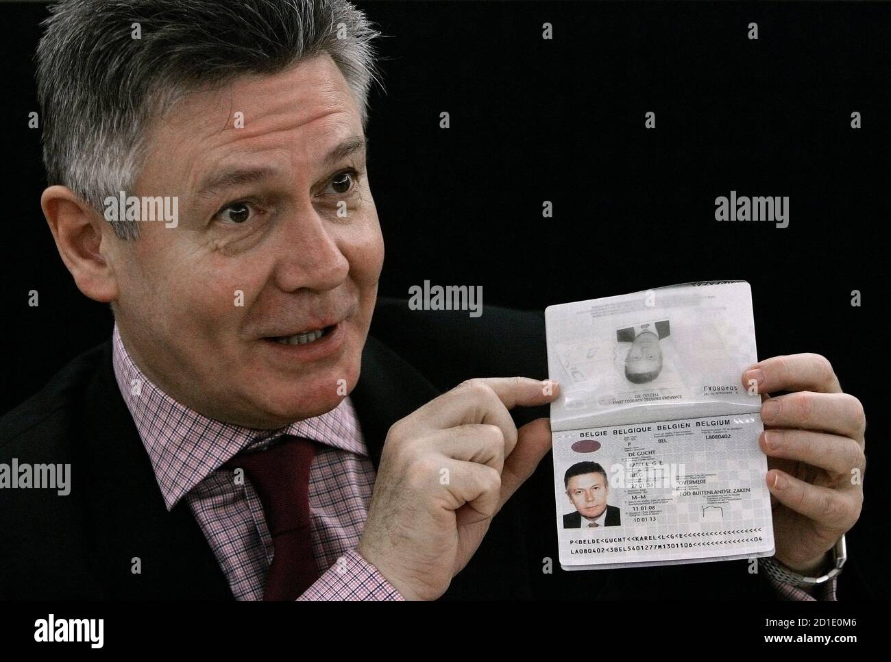 Belgium S Foreign Minister Karel De Gucht Displays His New Passport During A News Conference In Brussels