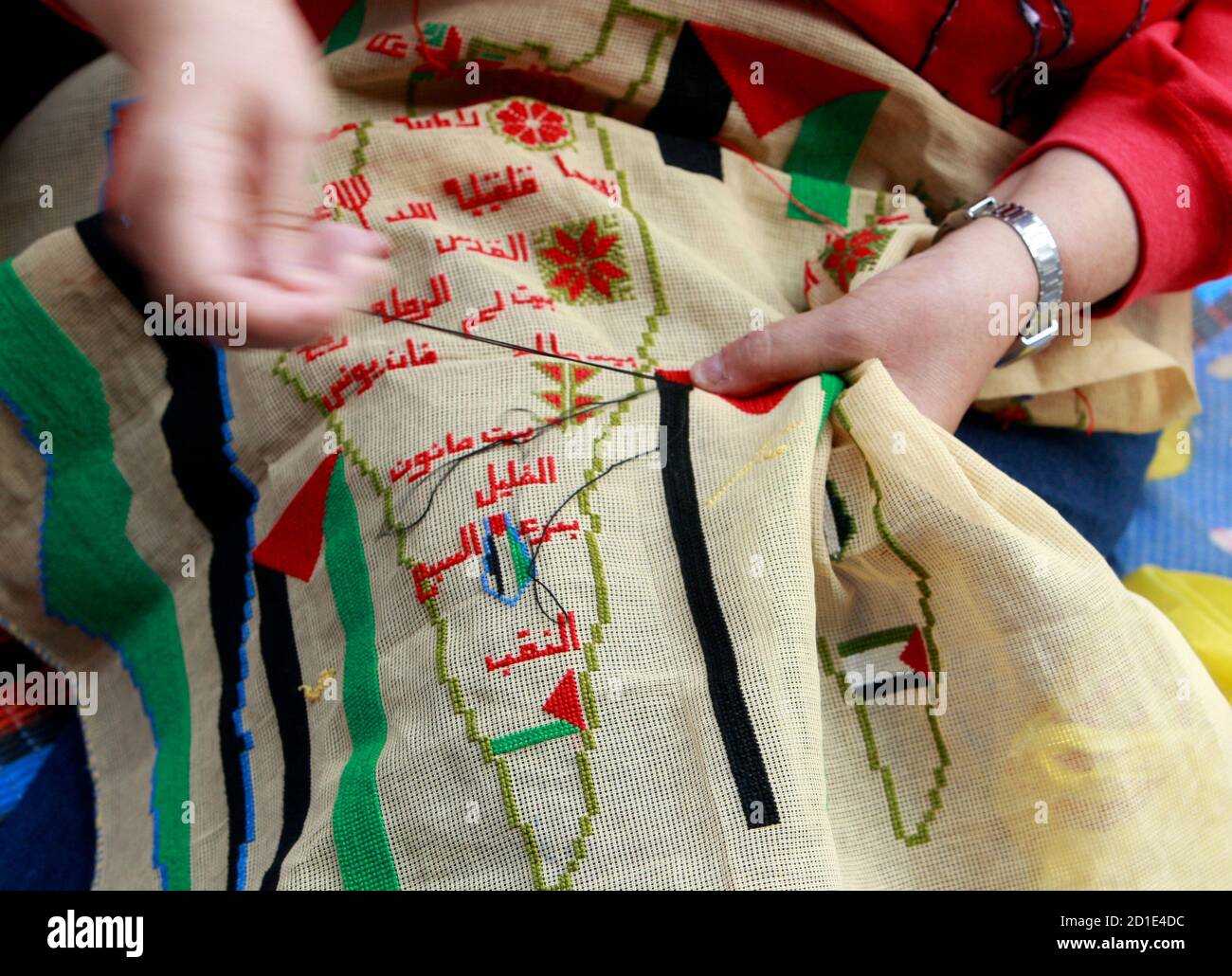 A Palestinian woman embroiders a map of Palestine to mark the 61st anniversary of Nakba at the Burj al-Barajneh refugee camp in Beirut May 15, 2009. Palestinians mark Nakba as a day of mourning for the establishment of Israel in 1948 after which an Arab-Israeli war brought the displacement of hundreds of thousands of Palestinians. REUTERS/Jamal Saidi   (LEBANON ANNIVERSARY POLITICS) Stock Photo