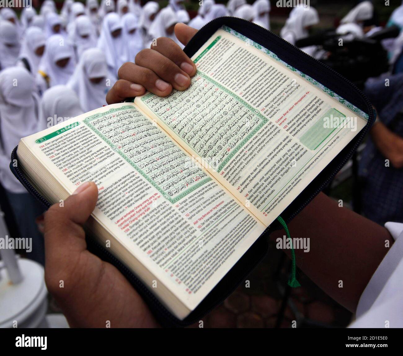An Indonesian Student Holds A Holy Koran As They Pray At Their School After It Reopened For Classes Following An Earthquake In Padang West Sumatra Province October 5 2009 Rescue Teams Combing<script async src=
