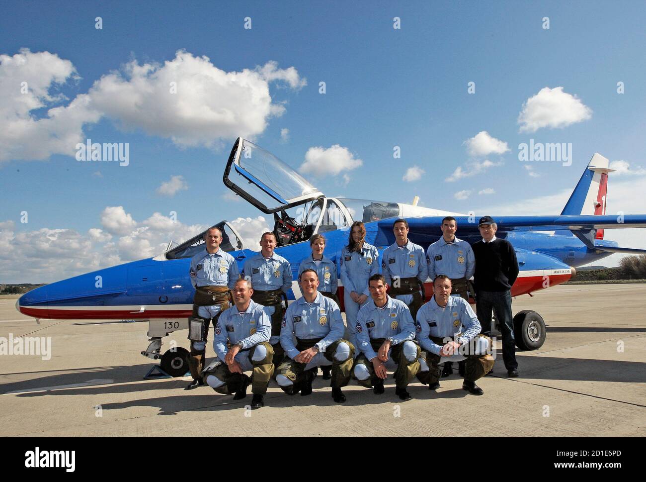 France's first lady Carla Bruni-Sarkozy (C), patron of the French aerobatic  squadron "Patrouille de France" poses with pilots after an exhibition in  Salon, April 2, 2010. REUTERS/Jean-Paul Pelissier (FRANCE - Tags: MILITARY