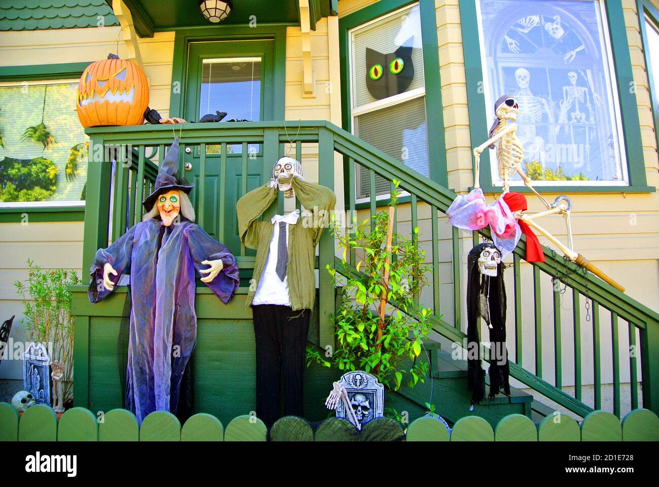 halloween display of witches pumpkins skeletons and black cats on front porch of petaluma home in california Stock Photo
