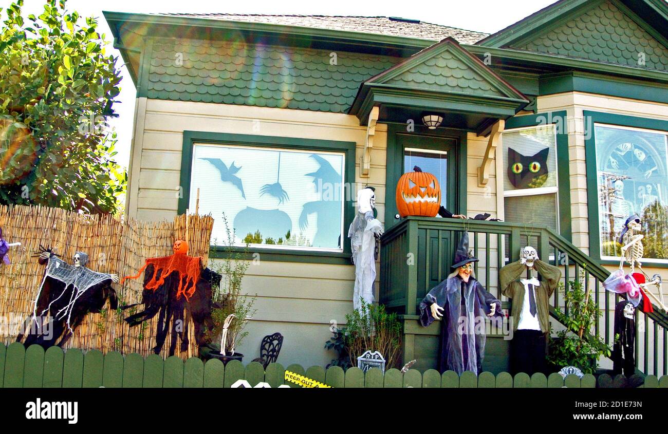 halloween display of witches pumpkins skeletons and black cats on front porch of petaluma home in california Stock Photo