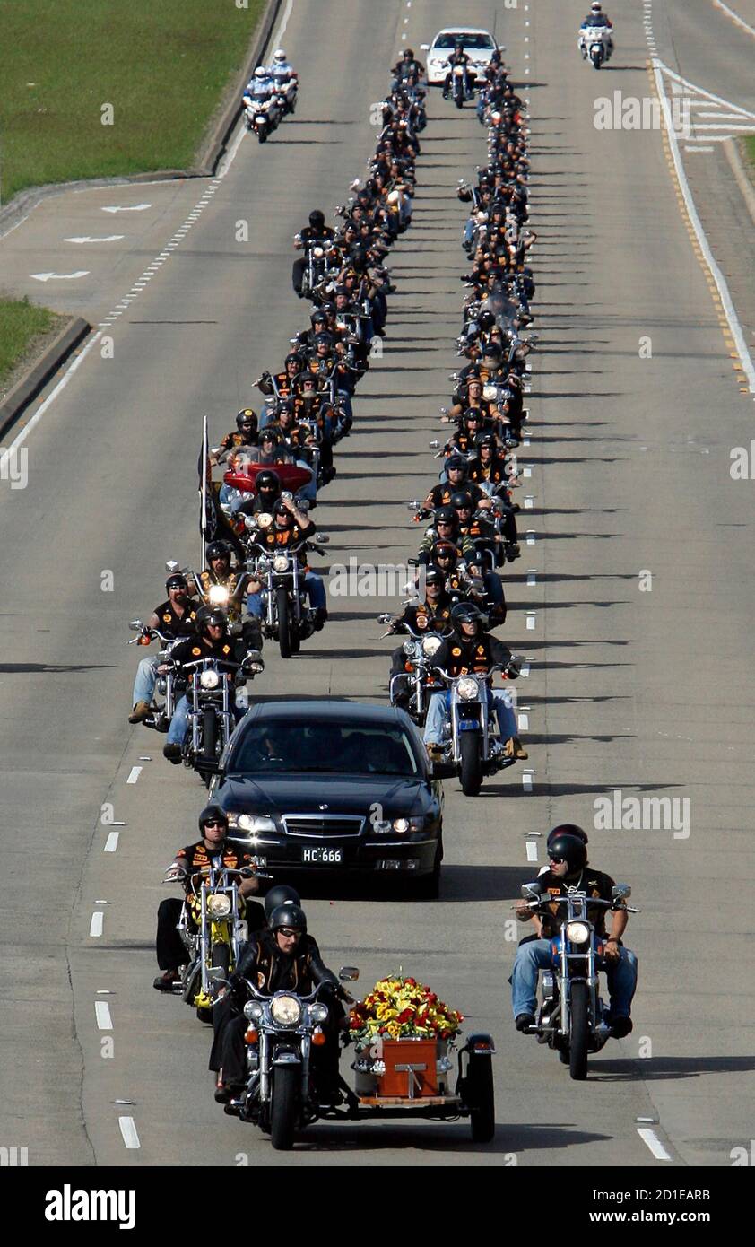 Members of the Bandidos biker gang form a procession behind the coffin of  one of their members during his funeral in western Sydney May 14, 2007.  Heavy police security was present at
