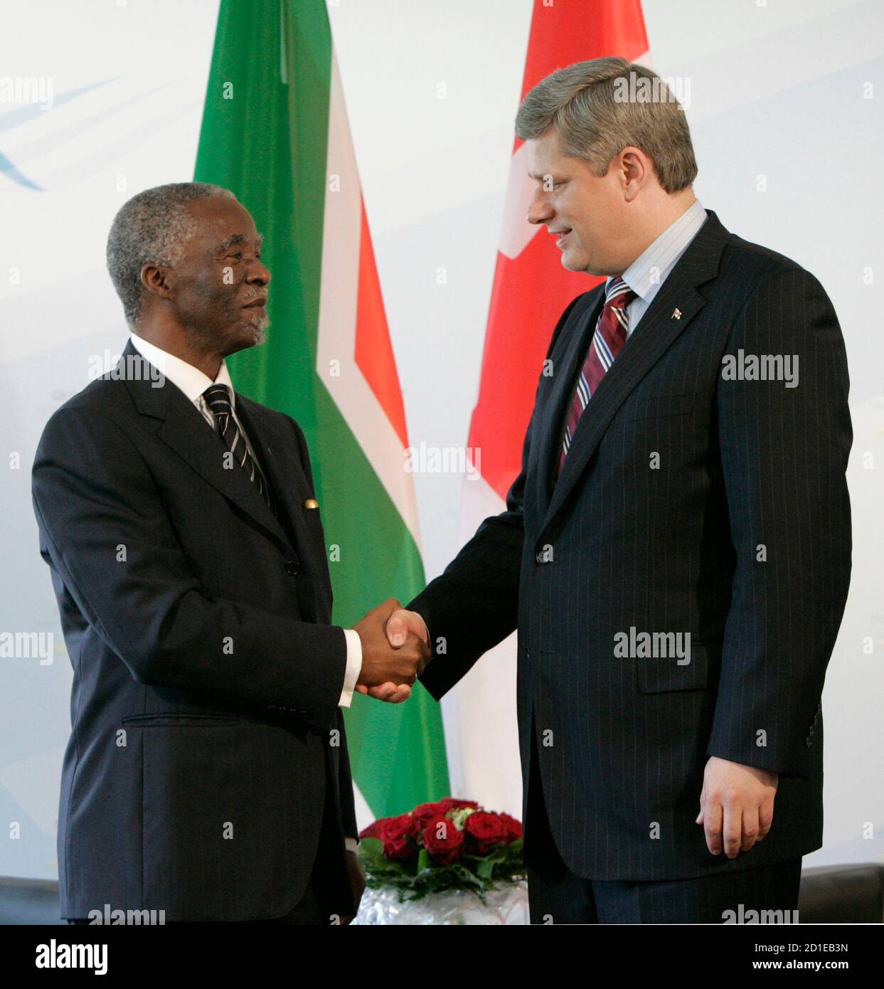 Canadian Prime Minister Stephen Harper (R) shakes hands with South African President Thabo Mbeki at the beginning of their meeting at the G8 Summit in Heiligendamm June 8, 2007.  World powers on  Friday pledged $60 billion to fight AIDS and other diseases ravaging Africa but development campaigners complained the Group of Eight had offered little fresh cash for the poor.         REUTERS/Chris Wattie   (GERMANY) Stock Photo