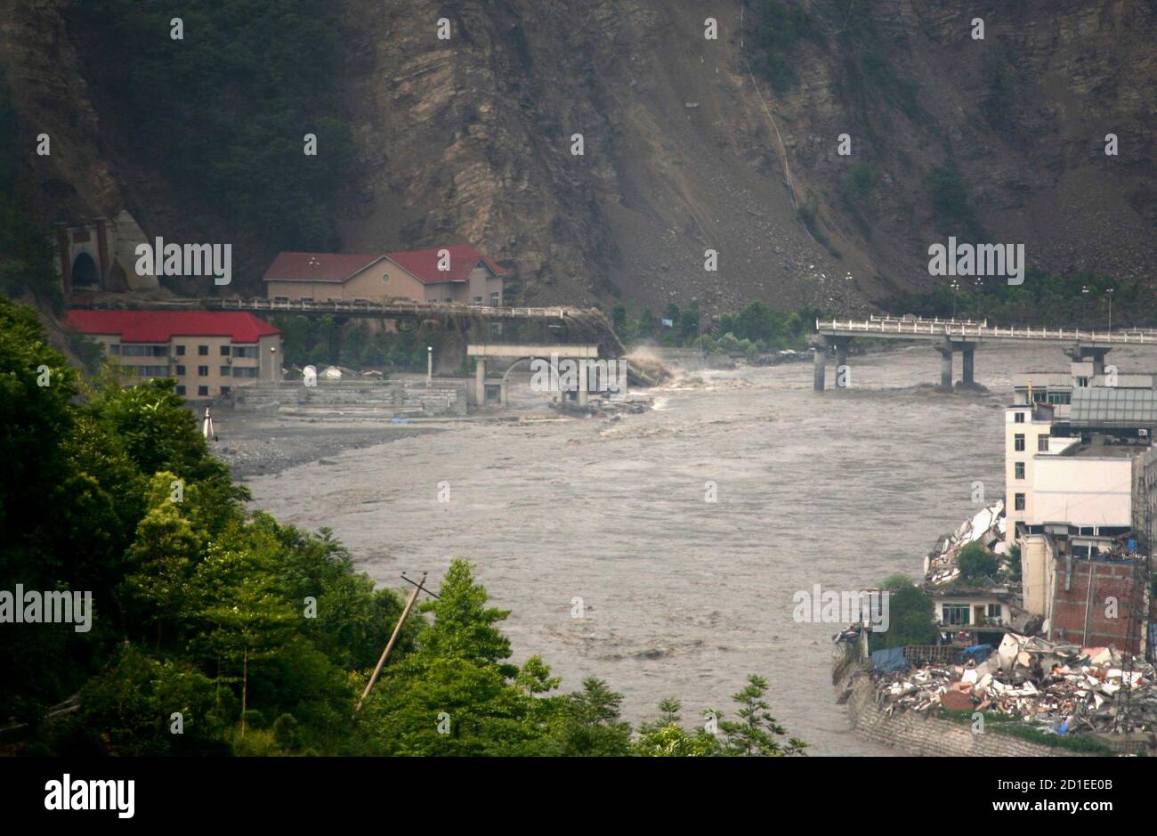 A bridge collapses as rushing water from a 'quake lake' flows through the earthquake-devastated city of Beichuan, Sichuan province June 10, 2008. Floodwaters crashed out of a dangerously unstable 'quake lake' in southwest China on Tuesday after soldiers blasted open a sluice, significantly easing the threat of disaster for hundreds of thousands of people downstream. REUTERS/Bo Bor (CHINA) Stock Photo