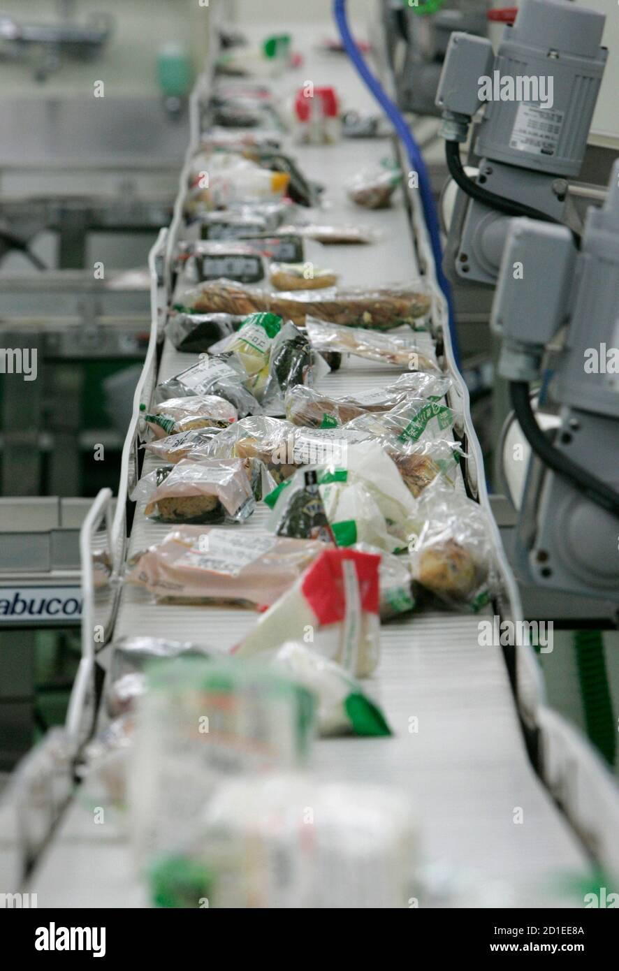 Food waste from convenience stores is carried on a conveyor at Agri Gaia  System, a waste food recycling company, in Sakura, east of Tokyo, May 30,  2008. With animal feed and fertilizer