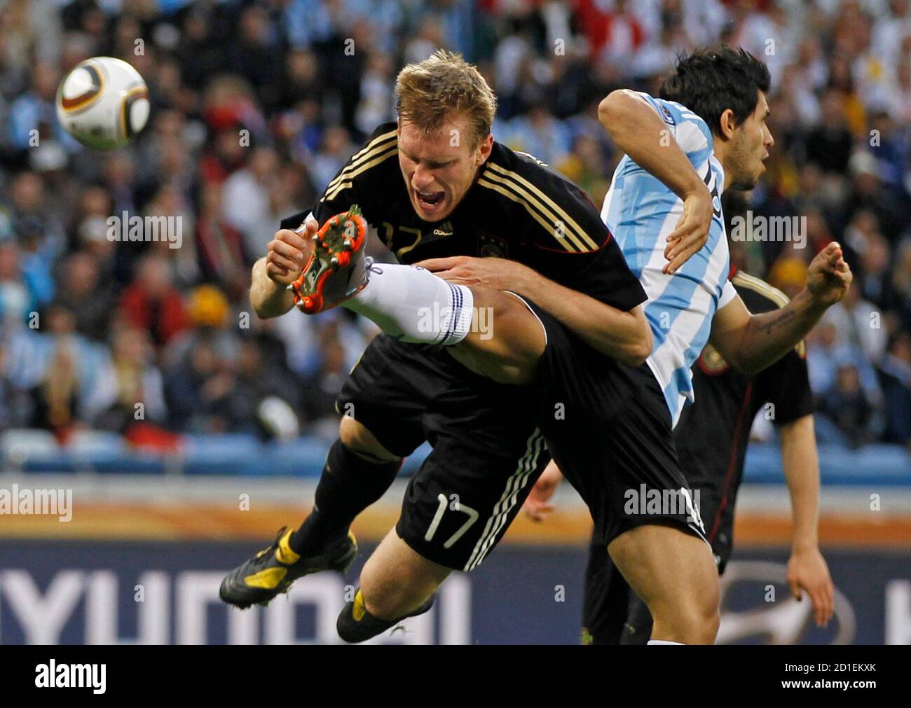 Argentina's Sergio Aguero fights for the ball with Germany's Per Mertesacker (L) during their 2010 World Cup quarter-final soccer match at Green Point stadium in Cape Town July 3, 2010. REUTERS/Carlos Barria (SOUTH AFRICA  - Tags: SPORT SOCCER WORLD CUP) Stock Photo