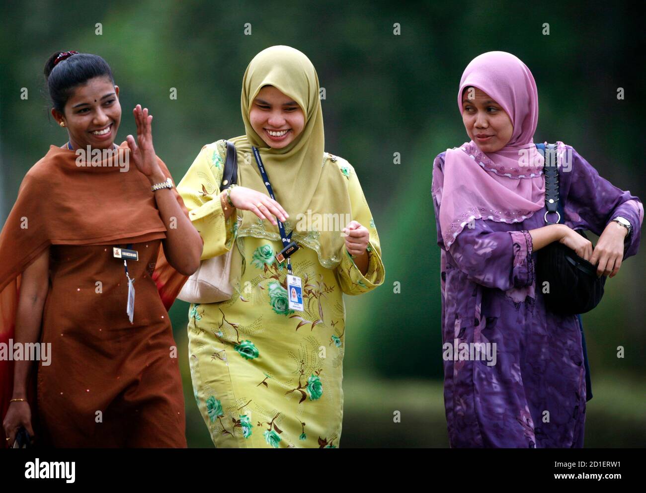 Malay And Indian Women Share A Light Moment As They Leave Office After Work In Putrajaya Outside Kuala Lumpur In This January 3 2007 File Photo As Malaysia Marks 50 Years Of