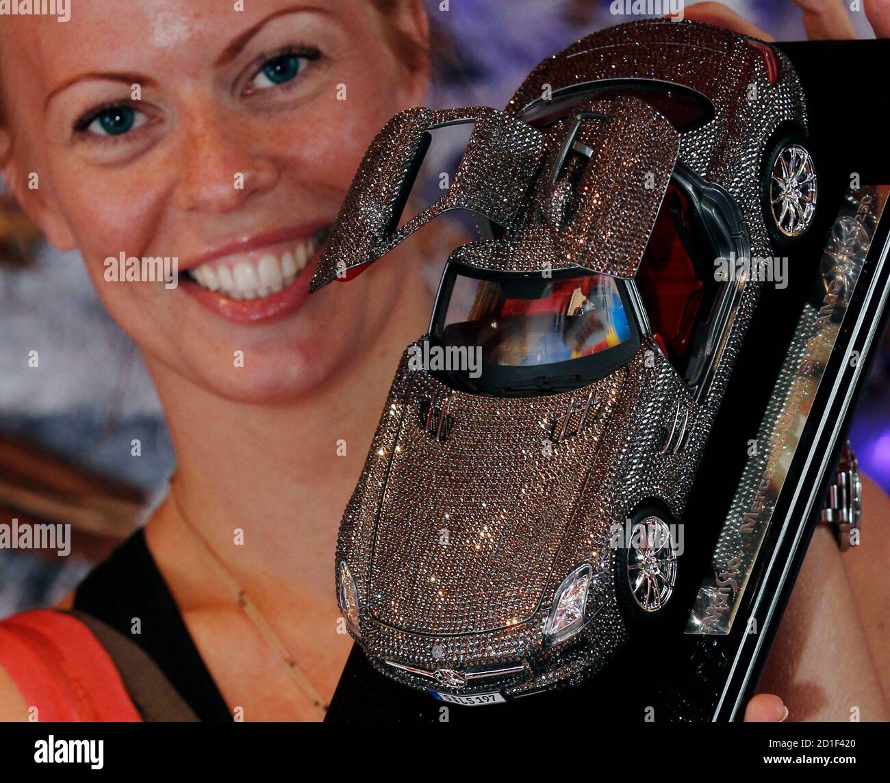Hamleys employee poses with a scale Mercedes Benz SLS AMG with Crystallized  Swarovski Elements for sale at Hamleys toy shop costing £1,500 in London,  July 1, 2010. Hamleys, which is celebrating its