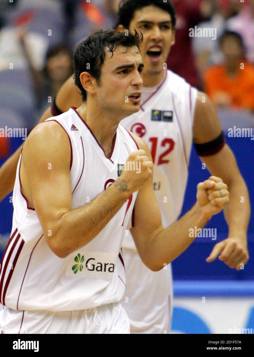 Turkey's Ender Arslan (L) celebrates with his team mate Kerem Gonlum after his game-winning score against Lithuania during their first round match at the world basketball championships in Hamamatsu, central Japan, August 19, 2006.  REUTERS/Issei Kato (JAPAN) Stock Photo