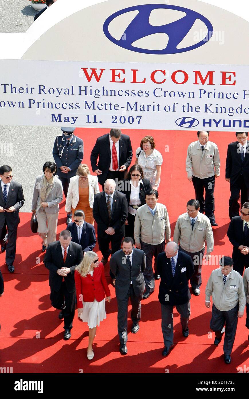 Norwegian Crown Prince Haakon (front row 3rd R) and Crown Princess Mette-Marit (4th R) visit one of the ships owned by Wilh. Wilhelmsen's Korean joint venture EUKOR, which handles all car exports from South Korea for Hyundai Motor Company and Kia Motors coporation, at Hyundai Motor's export port in Ulsan, about 410 km (256 miles) southeast of Seoul, May 11, 2007.  REUTERS/Jo Yong-Hak (SOUTH KOREA) Stock Photo