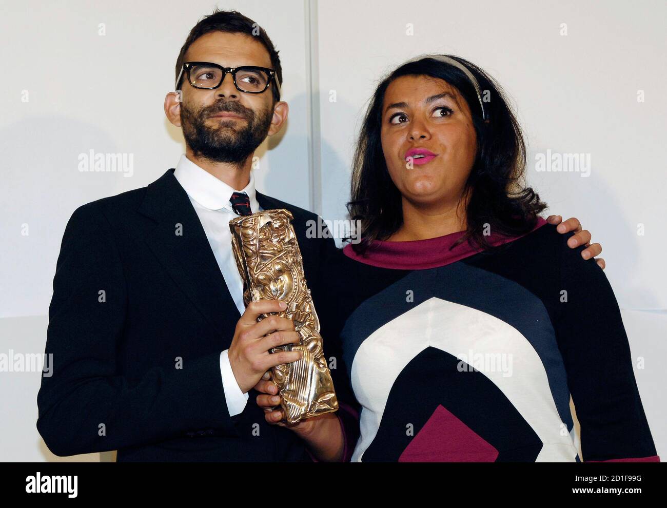 French directors Marjane Satrapi (R) and Vincent Paronnaud pose with their award for best debut film for 'Persepolis' at the French Cesar ceremony in Paris February 22, 2008. REUTERS/Gonzalo Fuentes (FRANCE) Stock Photo