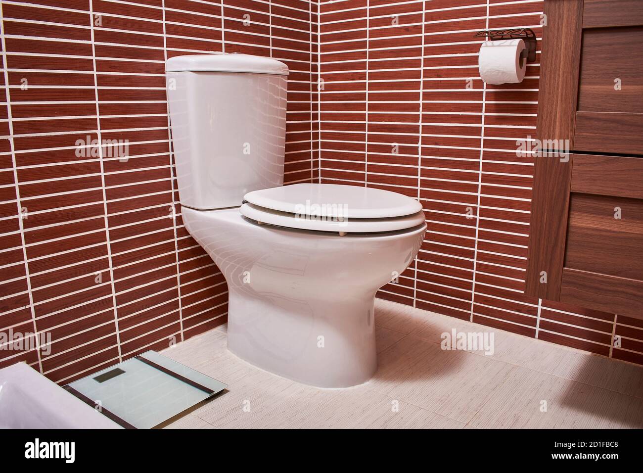 porcelain toilet bowl installed in a bathroom Stock Photo