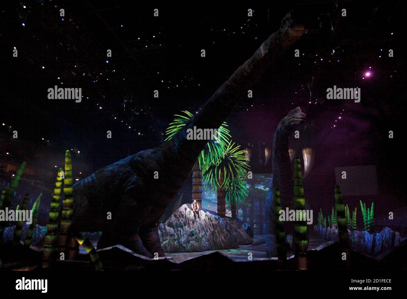 An actor performs during the show Dinosaurier Im Reich der Gigangten (Dinosaurs - In the empire of giants) during a dress rehearsal in Berlin, December 10, 2009. The 15 dinosaurs puppets up to 11 metres high and 17 metres long are partially remote driven in this show running from today until December 13 in the German capital.     REUTERS/Tobias Schwarz     (GERMANY - Tags: ENTERTAINMENT) Stock Photo