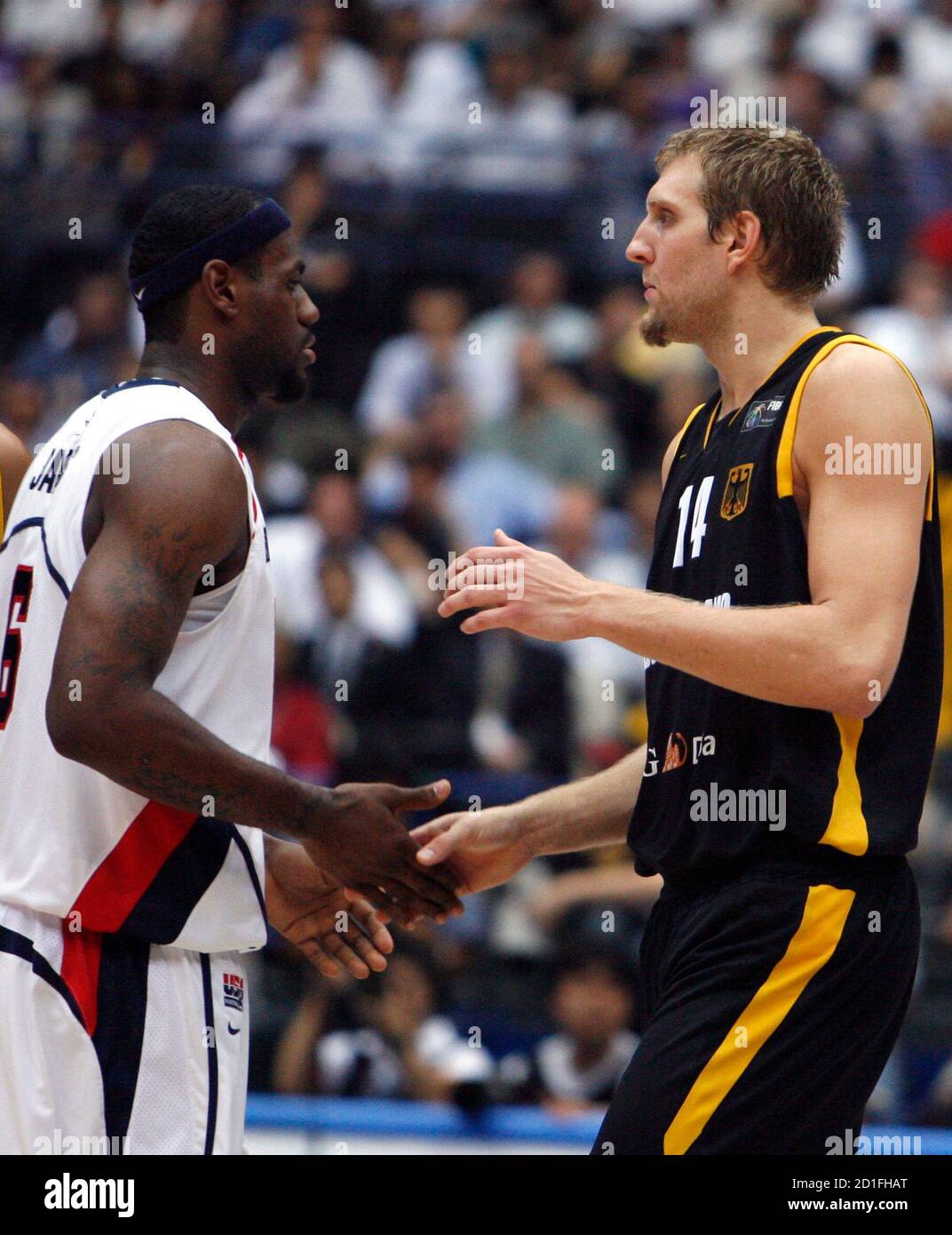Dirk Nowitzki (R) greets Lebron James 