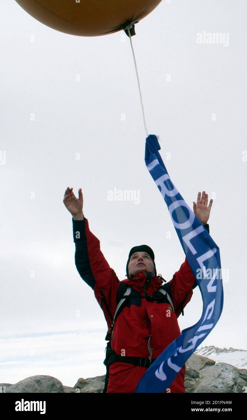 Norwegian Prime Minister Jens Stoltenberg releases a weather balloon in Antarctica at a ceremony to name a new mountain crag on January 19, 2008. Nations claiming parts of Antarctica are quietly staking out rights to the seabed, in stark contrast to the North Pole where Russia ostentatiously planted a flag to back its claim. The streamer says 'Trollveikja' -- or 'Troll Girl' -- the name of the 1,800 metre high peak about 250 km (155 miles) from the sea. Picture taken January 19, 2008. To match feature ANTARCTICA/CLAIMS  REUTERS/Alister Doyle    (ANTARCTICA) Stock Photo