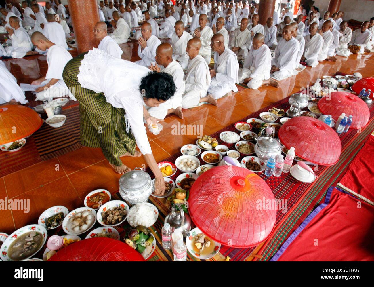 A woman arranges food during the annual "Vesak Bochea" ceremony at the
