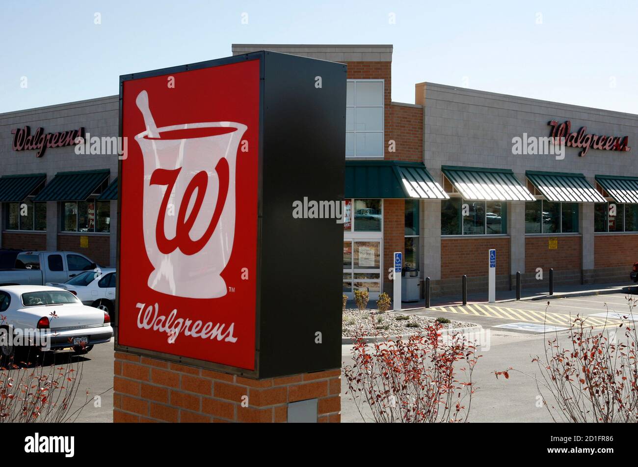 A customer drives away from the Walgreens in Westminster ...