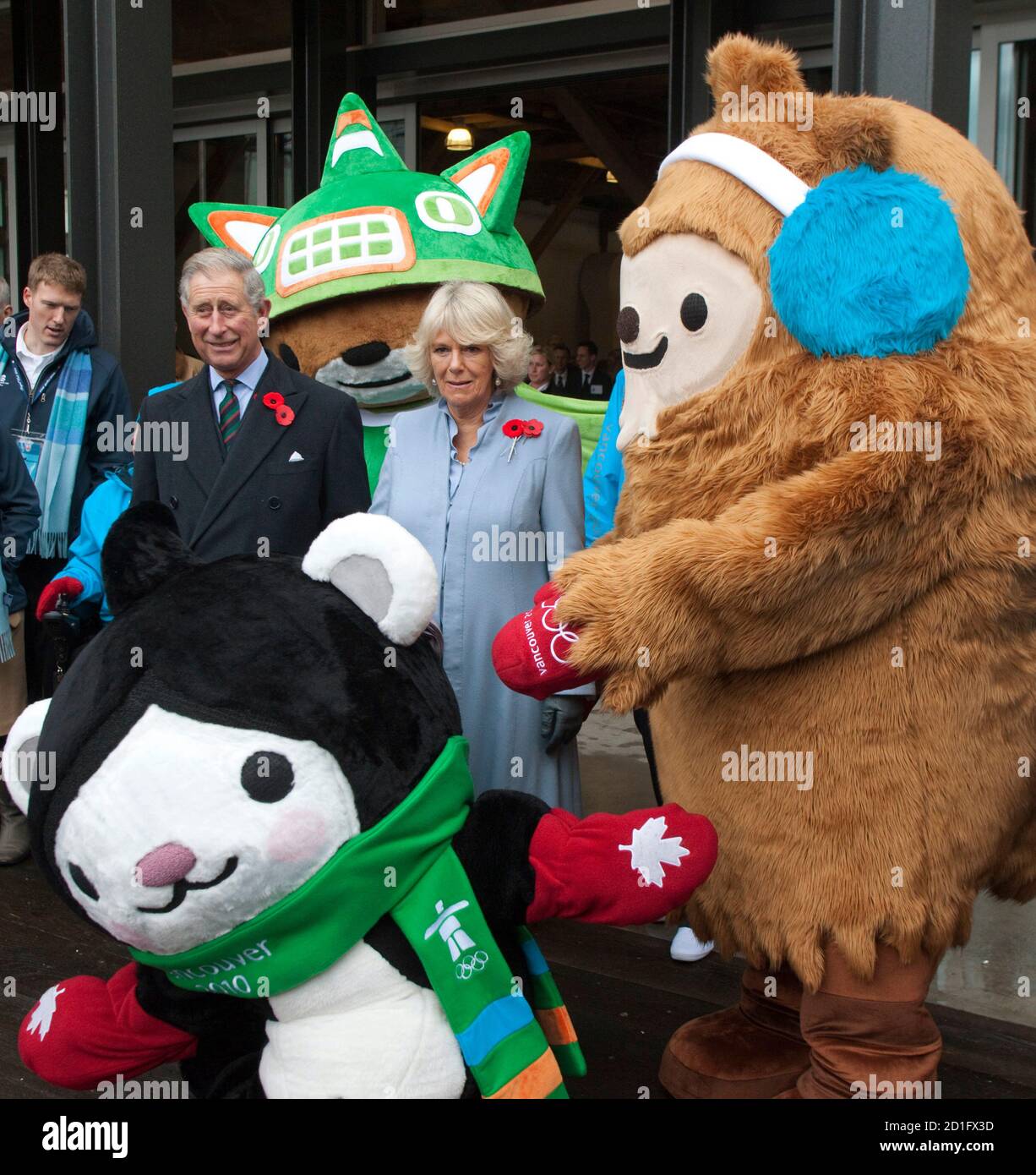 prince-charles-and-his-wife-camilla-duchess-of-cornwall-pose-with-the-mascots-for-the-2010-olympic-winter-games-quatchi-r-miga-c-and-sumi-during-a-visit-to-the-athletes-village-in-vancouver-british-columbia-november-7-2009-reutersandy-clark-canada-royals-politics-sport-olympics-2D1FX3D.jpg