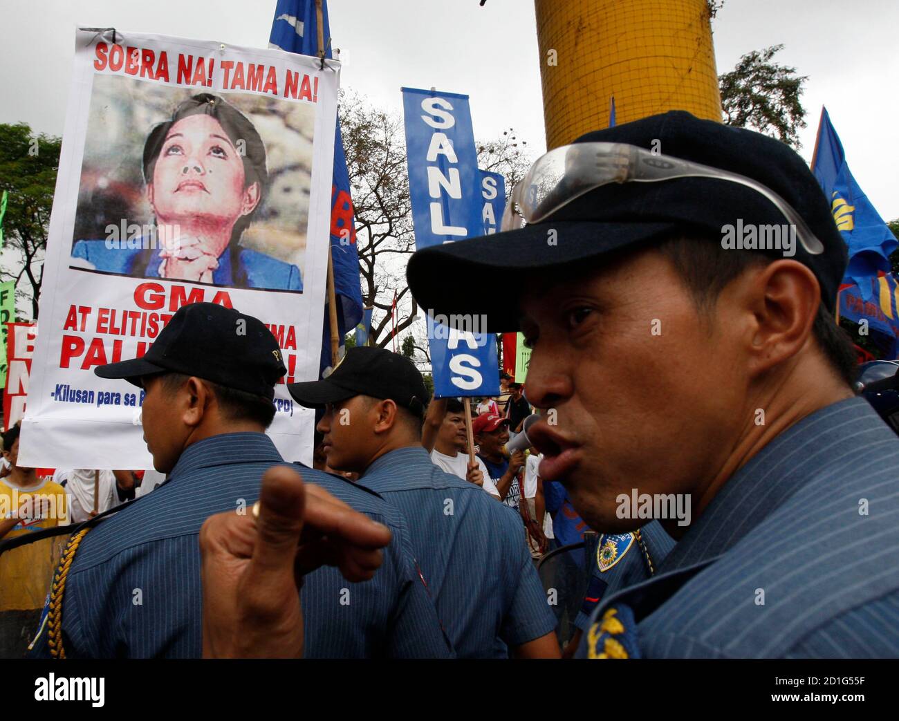 Police Keep Back Protesters Carrying A Sign Of Philippine President Gloria Macapagal Arroyo That Says Enough Is Enough During An Anti Government Protest Near The Edsa Shrine A Shrine Dedicated To The 1986