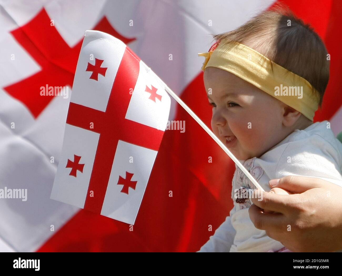A Georgian Baby Holds A National Georgian Flag During A Demonstration Outside The European Commission Headquarters In Brussels May 6 08 Several Hundred People Urged The European Union To Influence Russia To