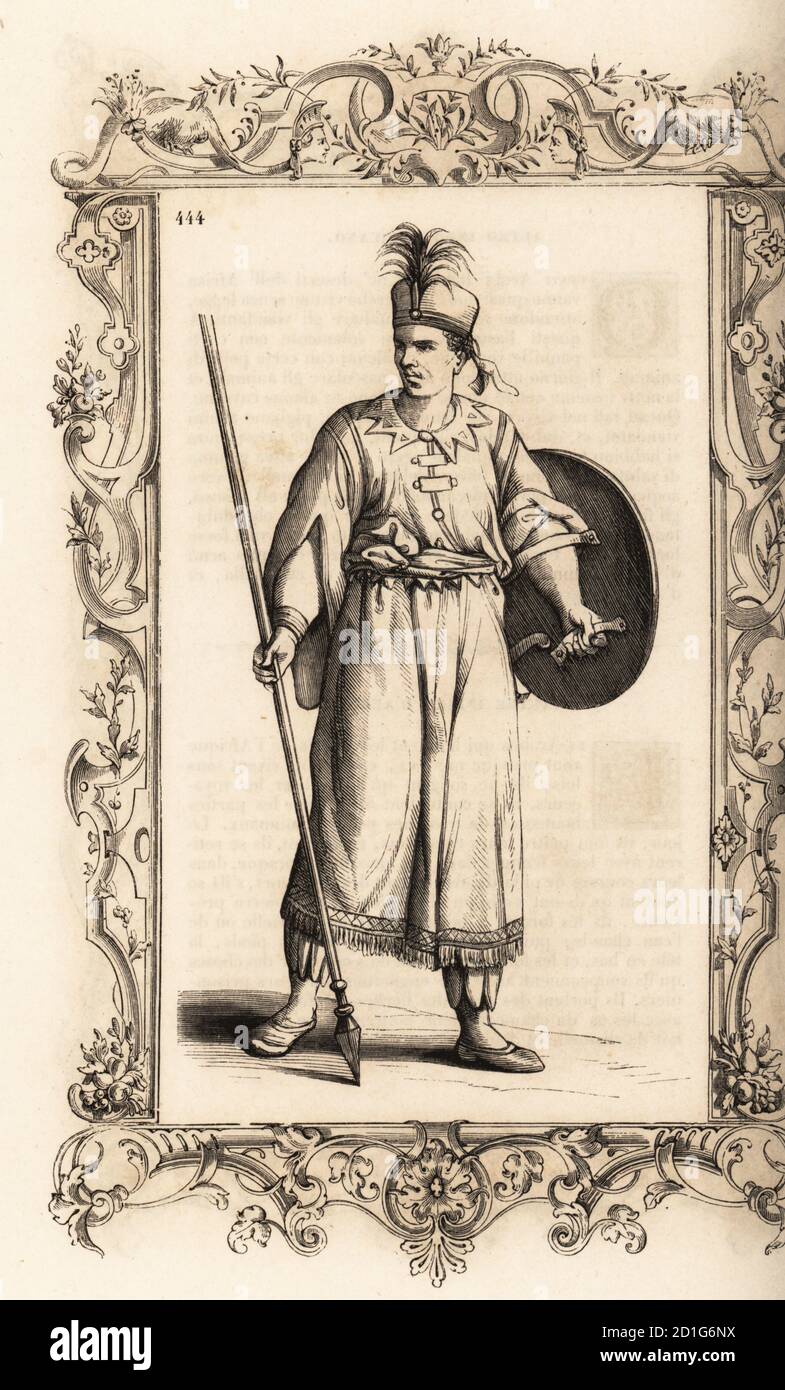 Warrior of the African kingdom of Djebel or Giabea. He carries a targe or round shield and a poisoned lance or assegai. Costume de Djebel, Royaume d’Afrique. Within a decorative frame engraved by H. Catenacci and Fellmann. Woodblock engraving by Gerard Seguin and E.F. Huyot after a woodcut by Christoph Krieger from Cesare Vecellio’s 16th century Costumes anciens et modernes, Habiti antichi et moderni di tutto il mondo, Firman Didot Ferris Fils, Paris, 1859-1860. Stock Photo