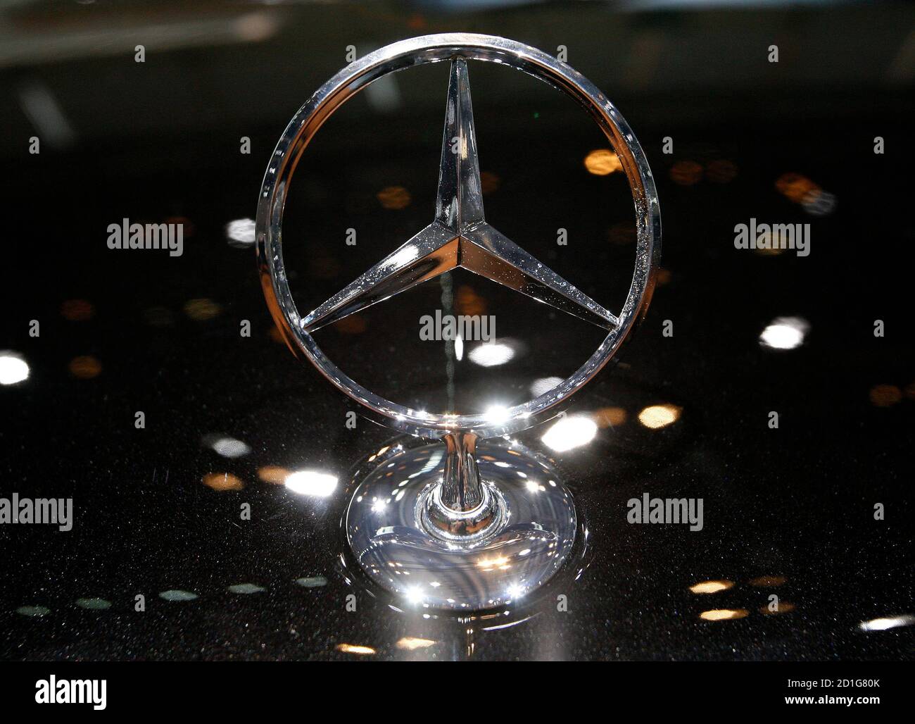 A Mercedes emblem is pictured on a new E series Blue Efficiency model  during the second media day of the 79th Geneva Car Show at the Palexpo in  Geneva March 4, 2009.