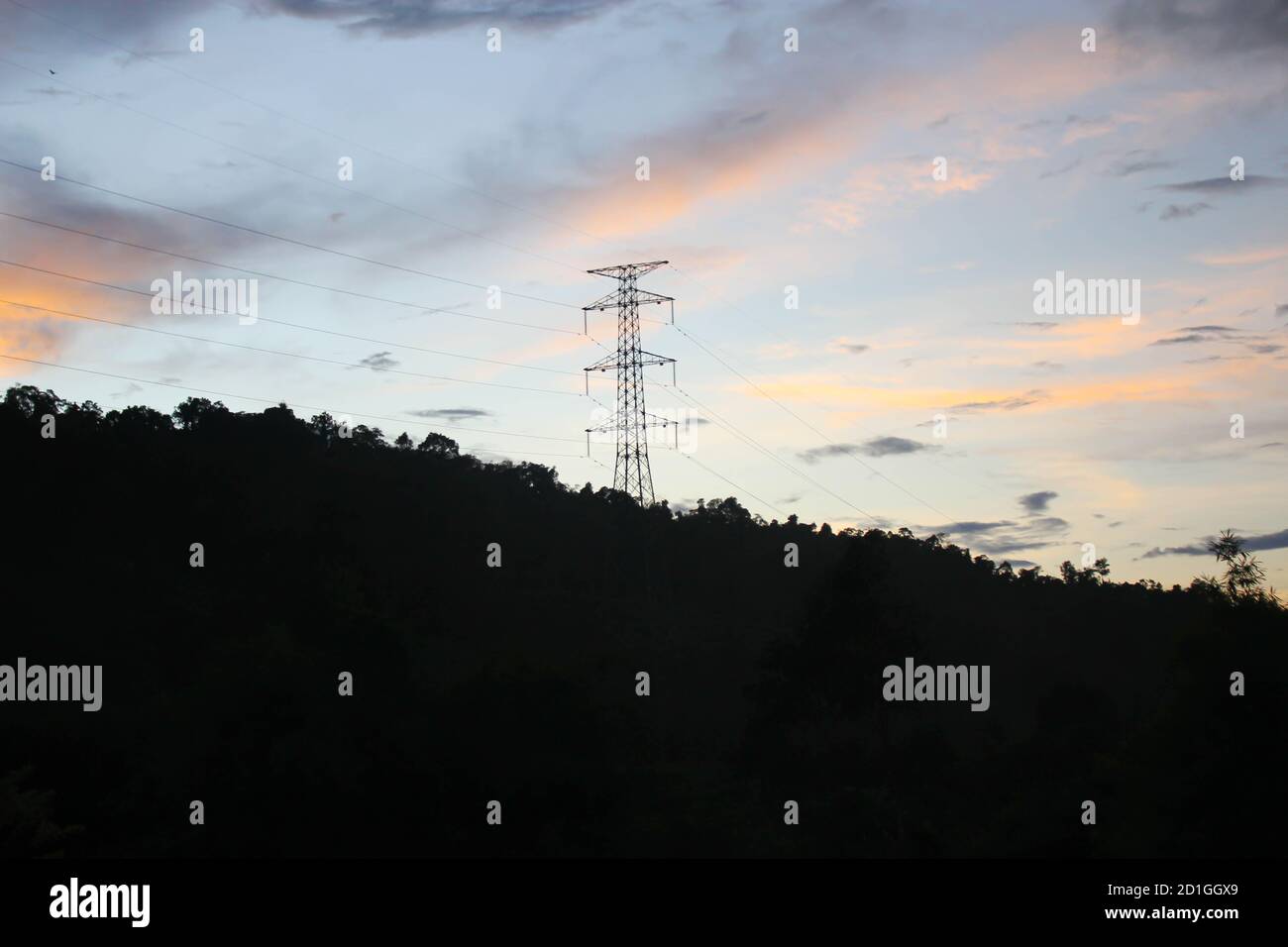 Electric post,High voltage pole of china on mountain in evening when sunset Stock Photo