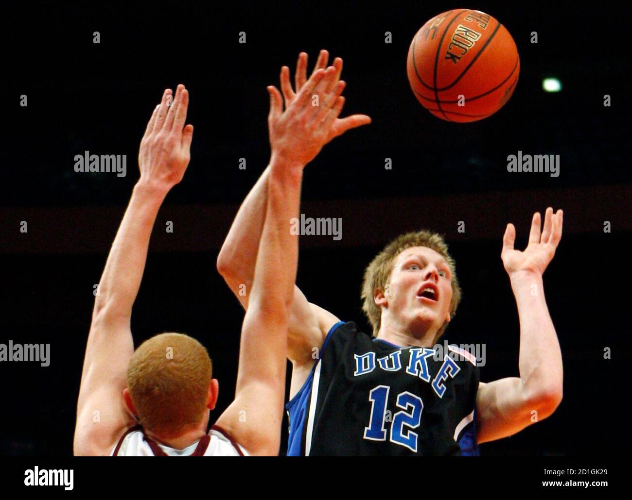 Duke University's Kyle Singler (R) goes up for a shot as he is defended by  University of Southern Illinois' Nick Evans in the first half of their  semifinal game at the 2008